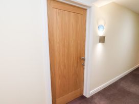 A door with a light fixture in a hallway at Mallard @ Engine Shed Whitby