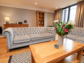 A living room with sofas, a coffee table, and a bookshelf at Mallard @ Engine Shed in Whitby