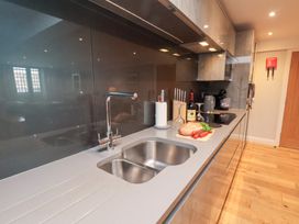 A kitchen with a sink and kitchen appliances at Mallard @ Engine Shed Whitby