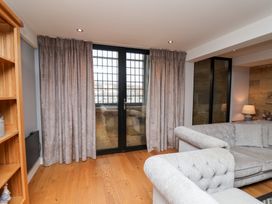 A living room with a sofa and sliding door at Mallard @ Engine Shed in Whitby