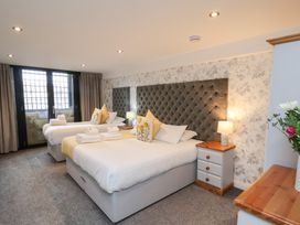A bedroom with two beds and a nightstand at Mallard @ Engine Shed Whitby
