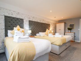 A bedroom with two beds and a dresser at Mallard @ Engine Shed in Whitby