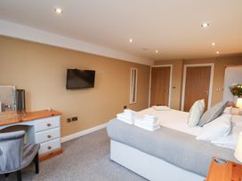 A bedroom with a bed and desk at Mallard @ Engine Shed Whitby