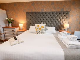 A bedroom with a bed, pillows, and a lamp at Mallard @ Engine Shed in Whitby