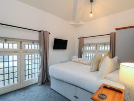 A bedroom with a bed and television at Evening Star @ Engine Shed Whitby