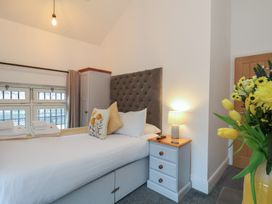 A bedroom with a bed and side table at Evening Star @ Engine Shed in Whitby