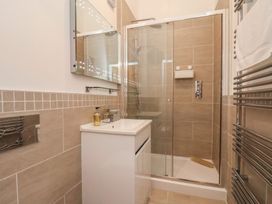 A bathroom with a shower and sink at Evening Star @ Engine Shed in Whitby