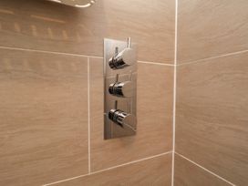 A set of shower controls on a wall at Evening Star @ Engine Shed in Whitby