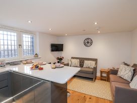A kitchen with seating area and dining setup at George Stephenson @ Engine Shed Whitby
