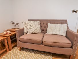 A living room featuring a sofa with cushions and a coffee table at George Stephenson @ Engine Shed in Whitby
