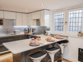 A kitchen with a countertop and bar stools at George Stephenson @ Engine Shed Whitby