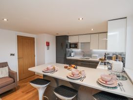 A kitchen with table and stools at George Stephenson @ Engine Shed in Whitby