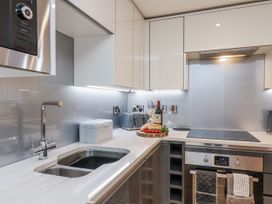 A kitchen with stove and wine bottle at George Stephenson @ Engine Shed Whitby