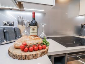 A kitchen with wine, bread, and tomatoes on the countertop at George Stephenson @ Engine Shed in Whitby