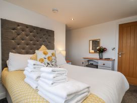 A bedroom with a bed and table at George Stephenson @ Engine Shed in Whitby