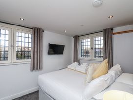 A bedroom with a bed and television at George Stephenson @ Engine Shed Whitby