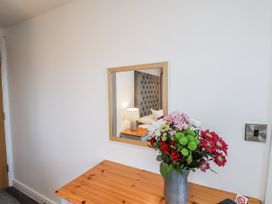 A bedroom with a table and flowers at George Stephenson @ Engine Shed in Whitby