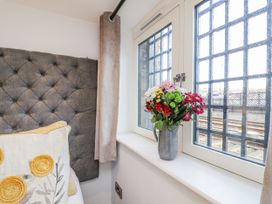 A bedroom with a window and a flower vase at George Stephenson @ Engine Shed Whitby