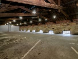 A garage with ceiling beams and windows at George Stephenson @ Engine Shed in Whitby