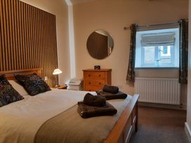 A bedroom with a bed and chest of drawers at Hemmel Cottage in Chatton