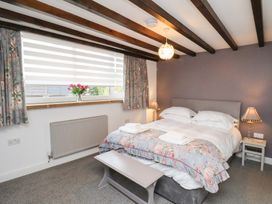 A bedroom with a double bed and window at Mill House in Robin Hood's Bay