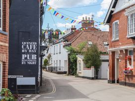 A street view with a cafe sign and colorful bunting at Meadow View Cottage in Lympstone