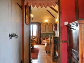 A view of a living room with a door and window at Lazy Hare at Jen's Orchard St Giles On The Heath
