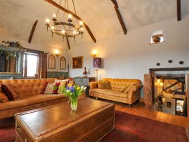 A living room with a sofa and coffee table at Lazy Hare at Jen's Orchard St Giles On The Heath