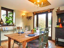 A dining room with a table and chairs at Lazy Hare at Jen's Orchard St Giles On The Heath
