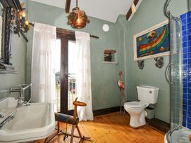 A bathroom with a bath tub and toilet at Lazy Hare at Jen's Orchard St Giles On The Heath