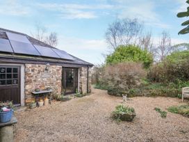 An outdoor area with a stone building at Lazy Hare at Jen's Orchard St Giles On The Heath