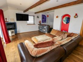 A living room with a sofa and television at Ocean Sail House in Termon near Dungloe, County Donegal
