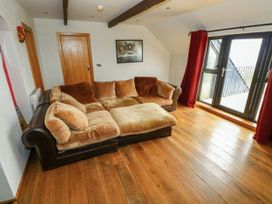 A living room with a sofa and a door at Ocean Sail House Termon near Dungloe, County Donegal