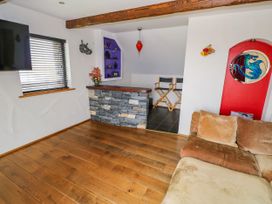 A living room with a television and bar area at Ocean Sail House in Termon near Dungloe, County Donegal