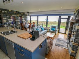 A kitchen and living area with a sofa and dining table at Ocean Sail House in Termon near Dungloe, County Donegal