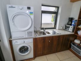A kitchen with a washing machine and dryer in Ocean Sail House, Termon near Dungloe, County Donegal