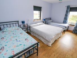 A bedroom with three beds at Ocean Sail House Termon near Dungloe County Donegal