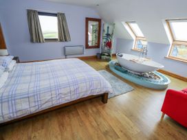 A bedroom with a bed and a bathtub at Ocean Sail House Termon near Dungloe County Donegal