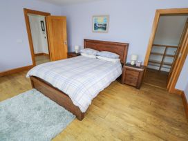 A bedroom with a bed and nightstand at Ocean Sail House Termon near Dungloe County Donegal