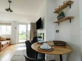 A dining area with a table and chairs at Bwthyn in Moelfre