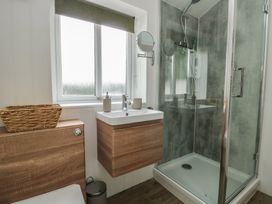 A bathroom with a shower and a wash basin at Bwthyn Moelfre