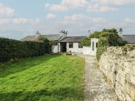 A house with a garden and pathway at Bwthyn Moelfre