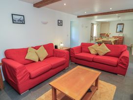 A living room with red sofas and a coffee table at Dale Barton in Wells