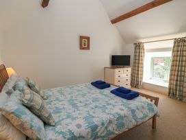 A bedroom with a bed and dresser at Dale Barton in Wells