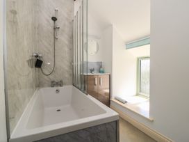 A bathroom with a shower over a bathtub at Dale Barton in Wells