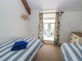 A bedroom with two beds and a window at Dale Barton in Wells