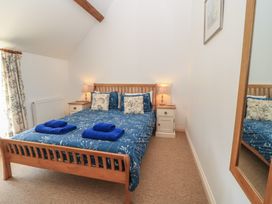 A bedroom with a bed and bedside table at Dale Barton in Wells