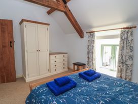 A bedroom with a bed and wardrobe at Dale Barton Wells