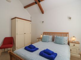 A bedroom with a bed and wardrobe at Dale Barton in Wells