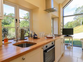 A kitchen with a window and appliances at Pheasant Cottage Priston Village BATH